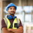 istockphoto-1346124841-612x612 Indian construction site manager standing with folded arms wearing safety vest and helmet, thinking at construction site. Young architect watching construction site with confidence. Portrait of mixed race manual worker looks at his work with satisfaction.